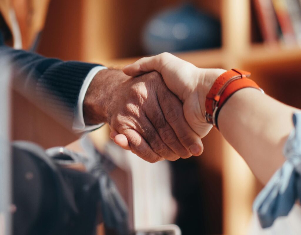 A close-up image of two people shaking hands, symbolizing a business agreement.